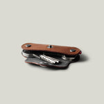 Multi-key pouch made of brown leather on a light gray background