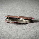 Multi-key pouch made of brown leather on a gray background
